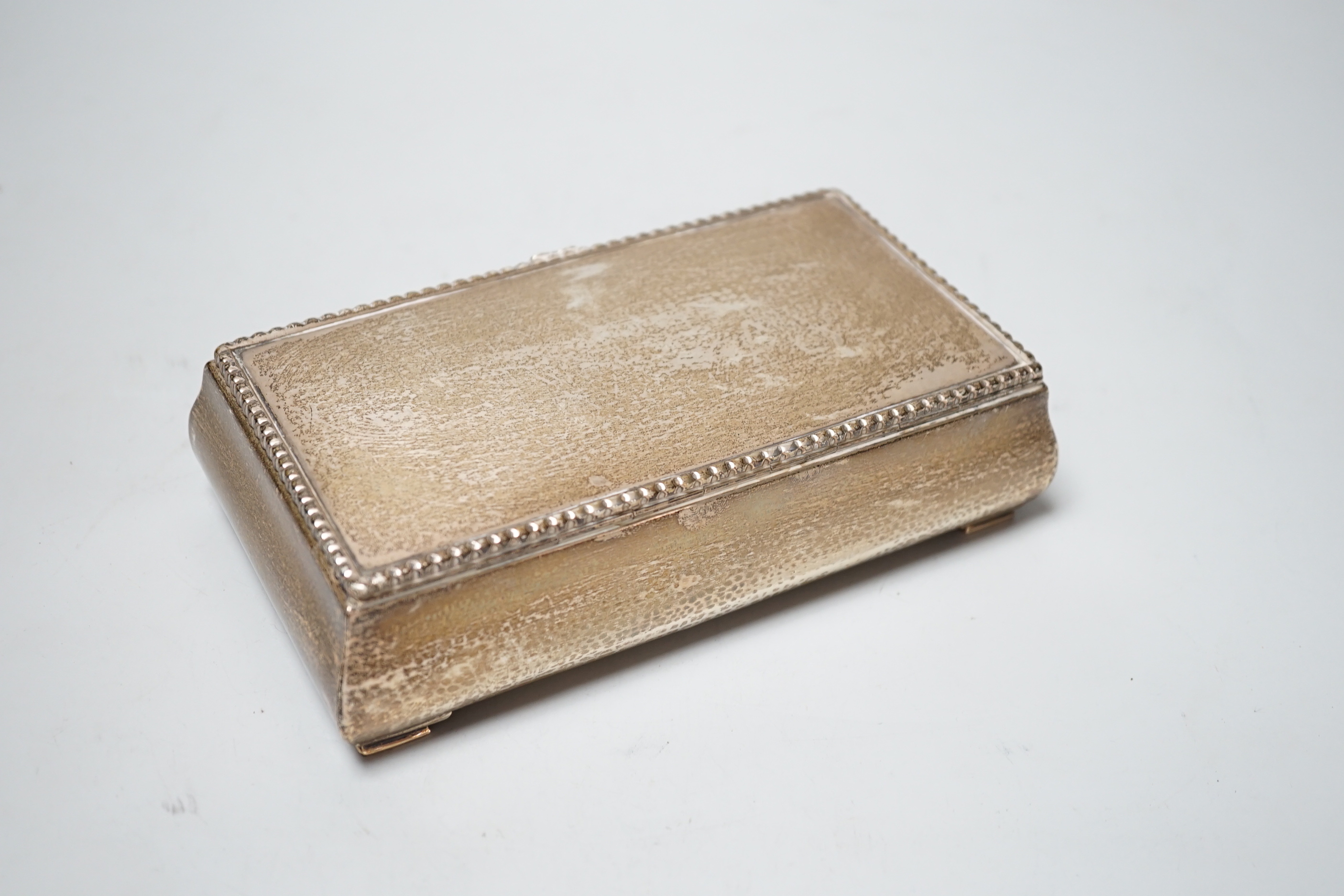 A George V hammered silver mounted rectangular cigarette box, Goldsmiths & Silversmiths Co Ltd, London, 1928, 18.5cm.